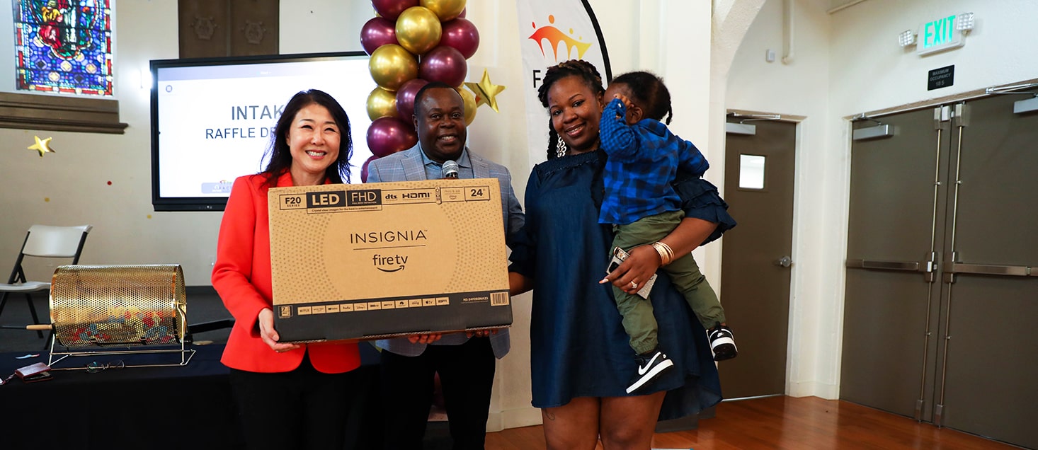 2-Mom with son winning a raffle price at FACE Seminar